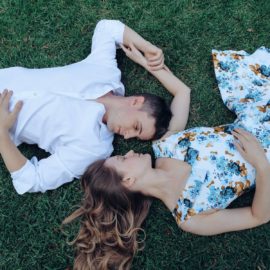 Image of two people lying down with their feet in opposite directions
